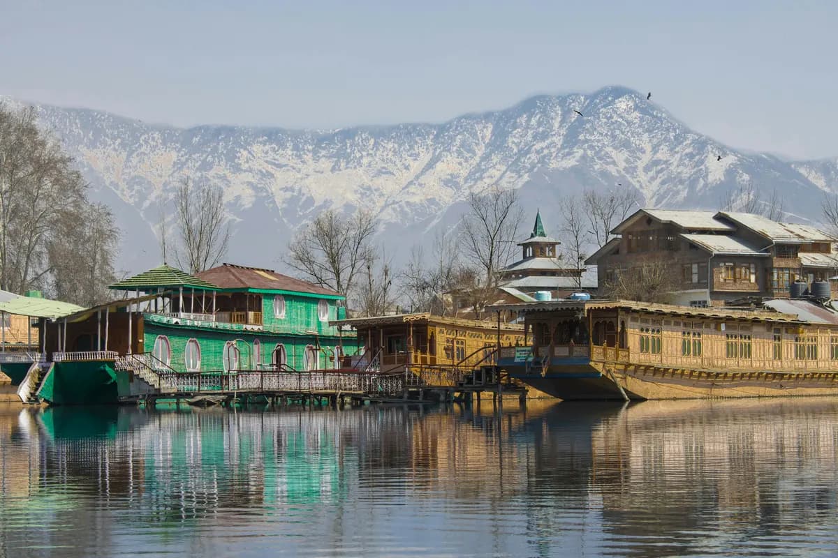 Houseboats on Dal Lake with snow-capped mountains behind, Srinagar