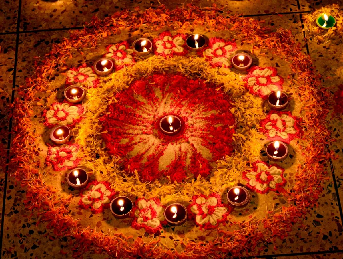 Diyas and rangoli lit for Diwali
