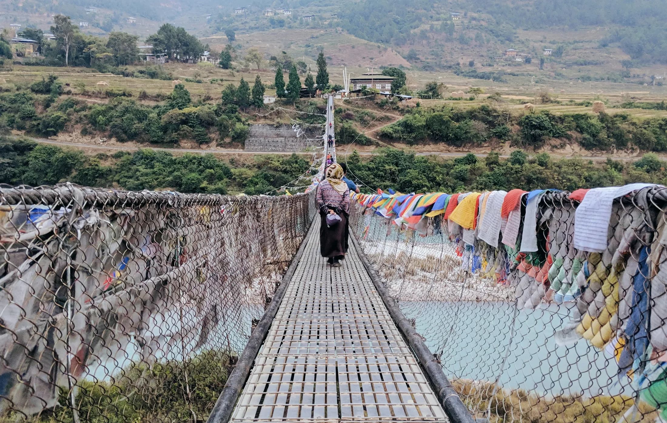 Punakha's suspension bridge strung with prayer flags over the Pho Chhu river