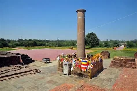 The ancient Ashoka Pillar at Lumbini, decorated with prayer flags